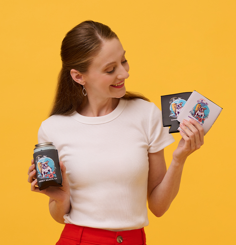A woman holding drink koozies printed with surfing dog mascot designs.