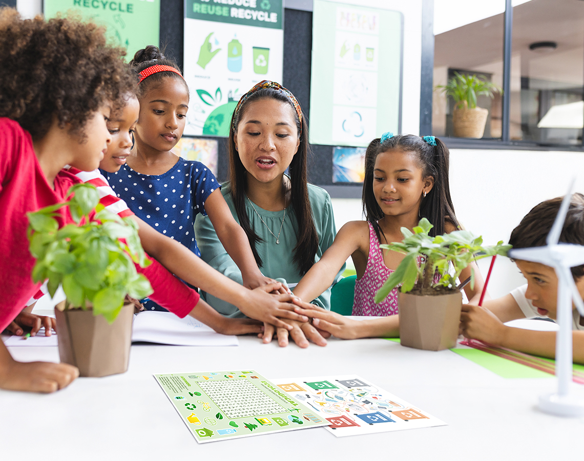 Teacher leading students in sustainability activity in classroom.