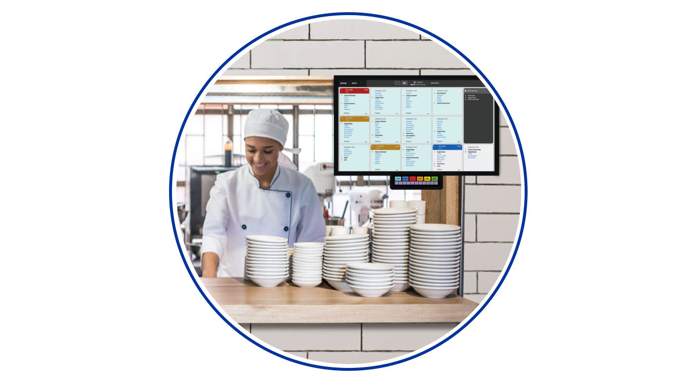 Food service worker next to a KDS screen
