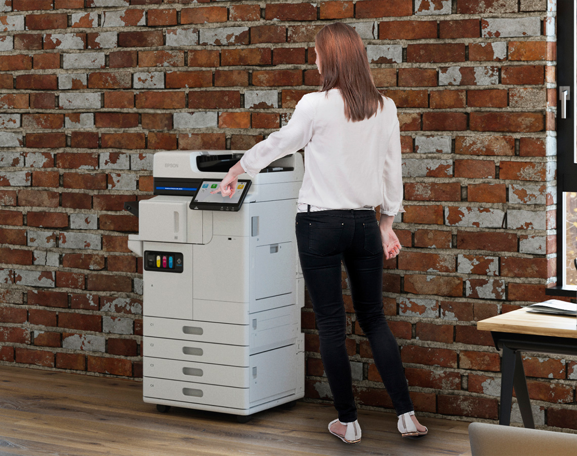 Person standing by Epson printer