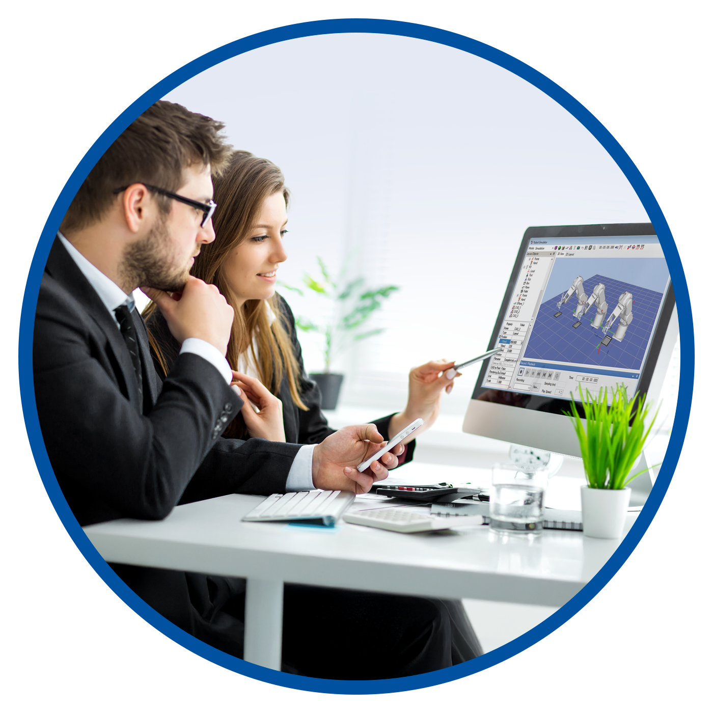 A man and a woman looking at RC+ software on a computer screen.