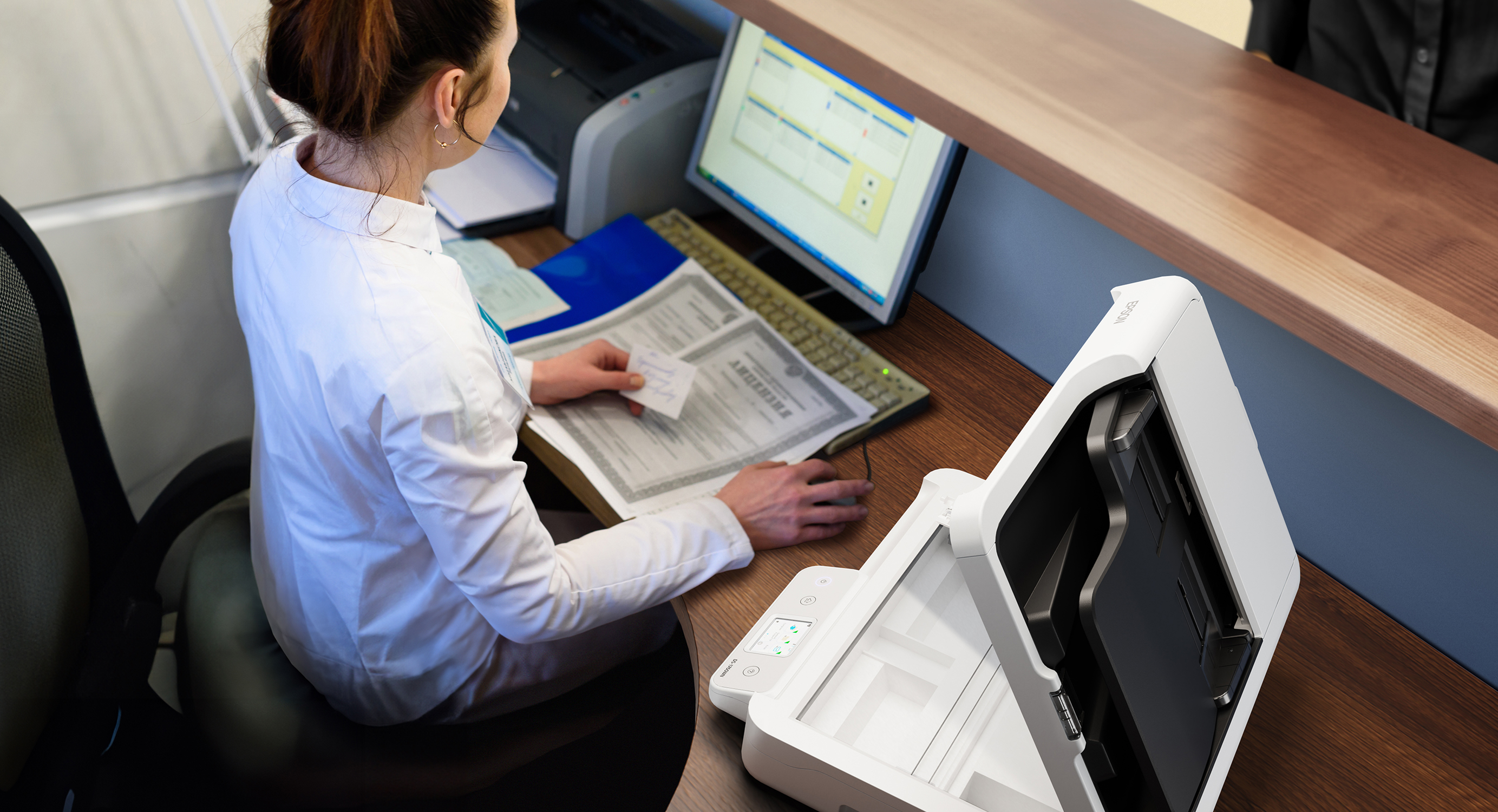 A government worker uses an Epson DS-1760WN.