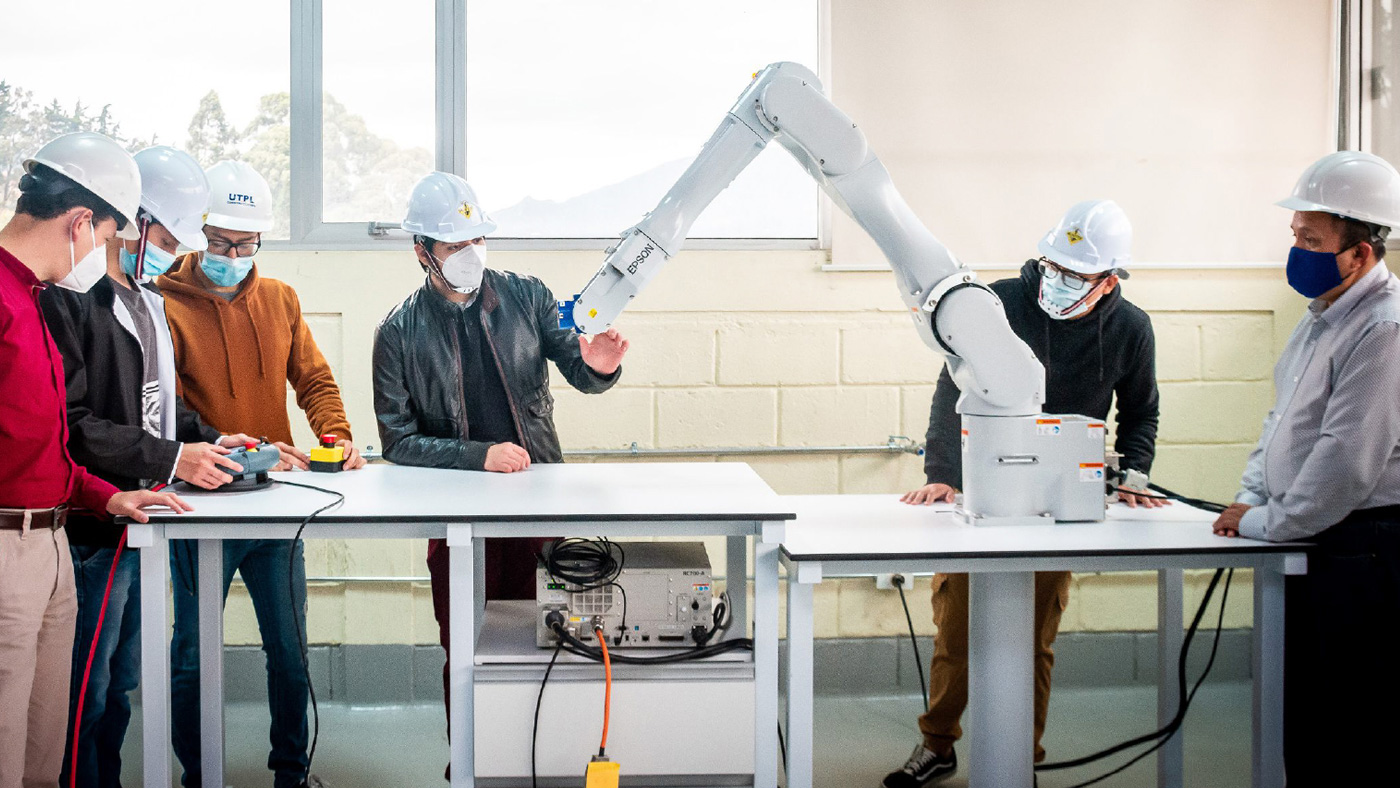Students receiving hands-on training with an Epson robot