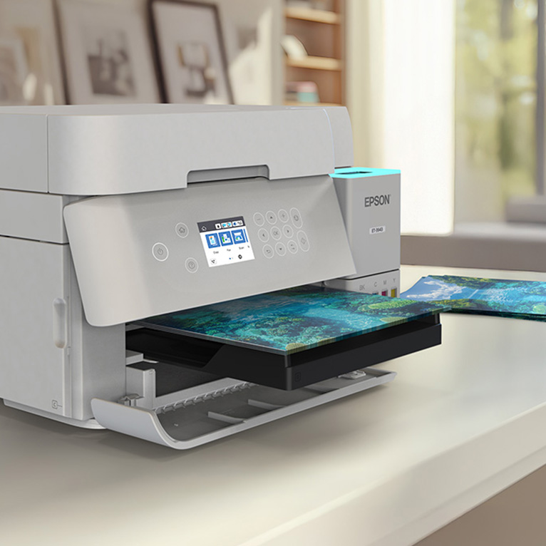 An Ecotank printer on a desk with a printed sheet coming out