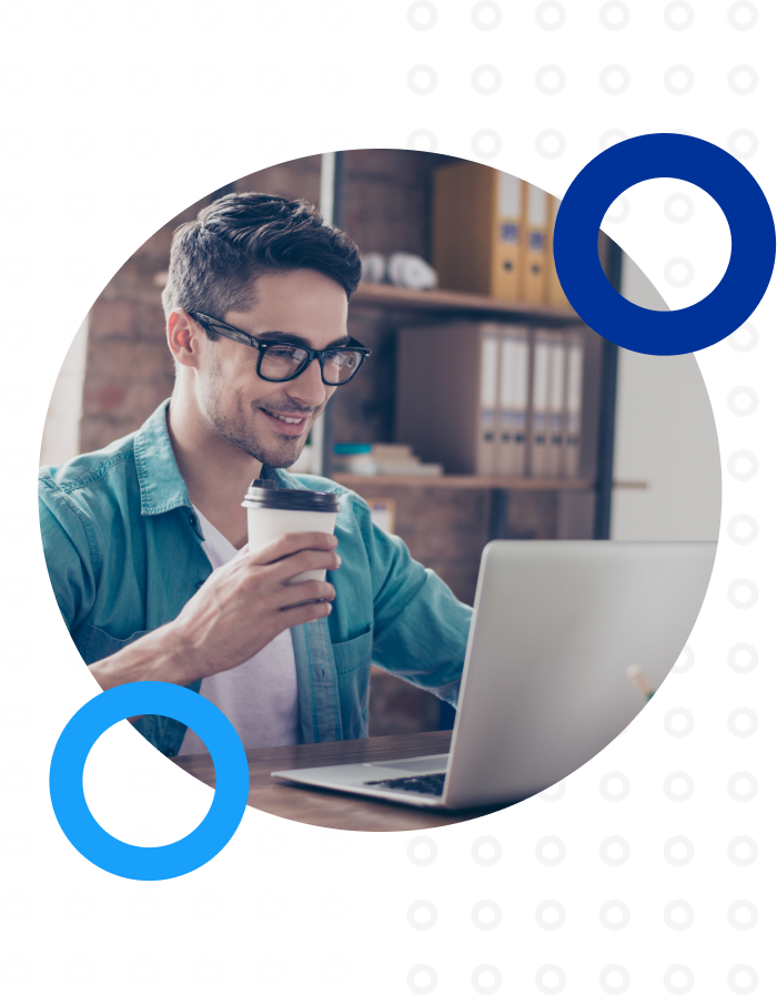 Man using a computer drinking coffee