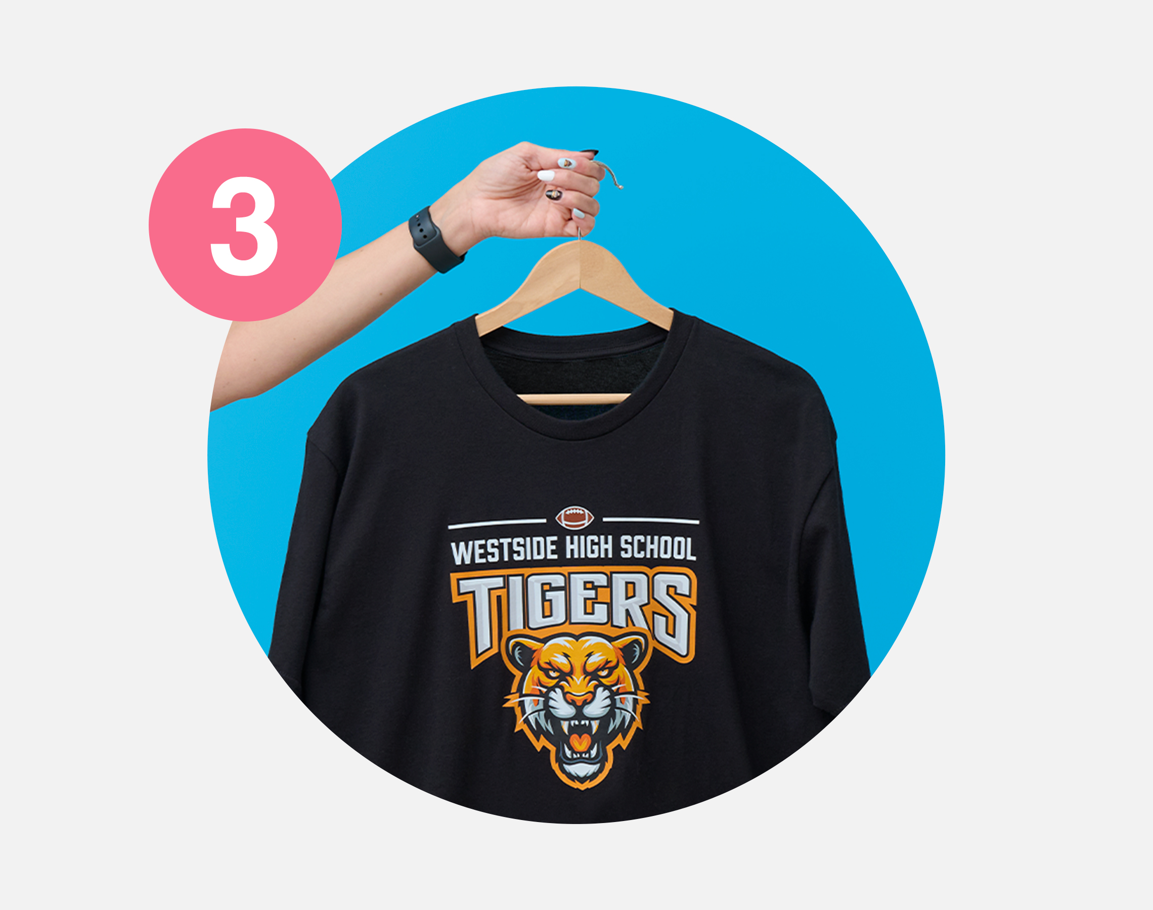 T-shirt printed with tiger mascot logo, hanging on hanger.
