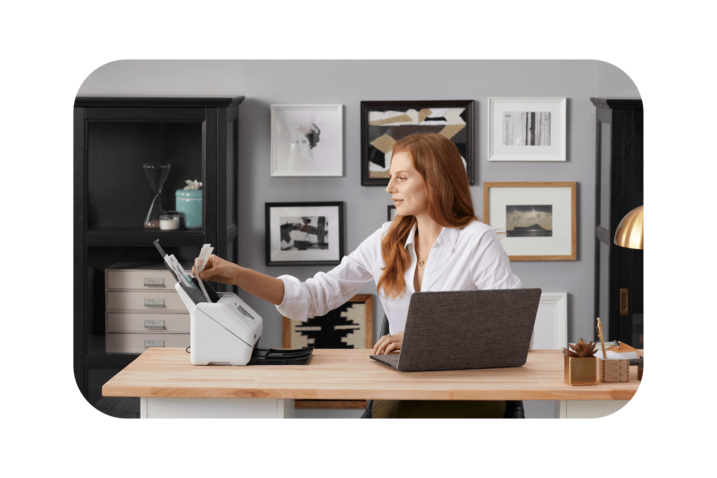 woman at desk scanning business receipts on Epson RapidReceipt scanner