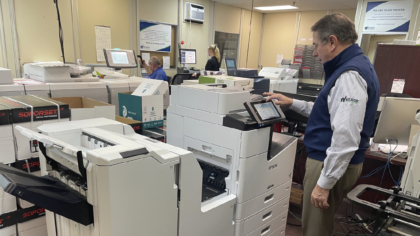 A man using an Epson Business Inkjet workgroup printer