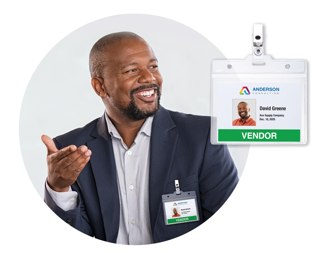 A corporate vendor in a business meeting wearing a colorful visitor ID badge.