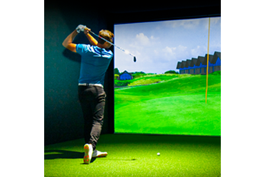 Golfer playing with golf simulation