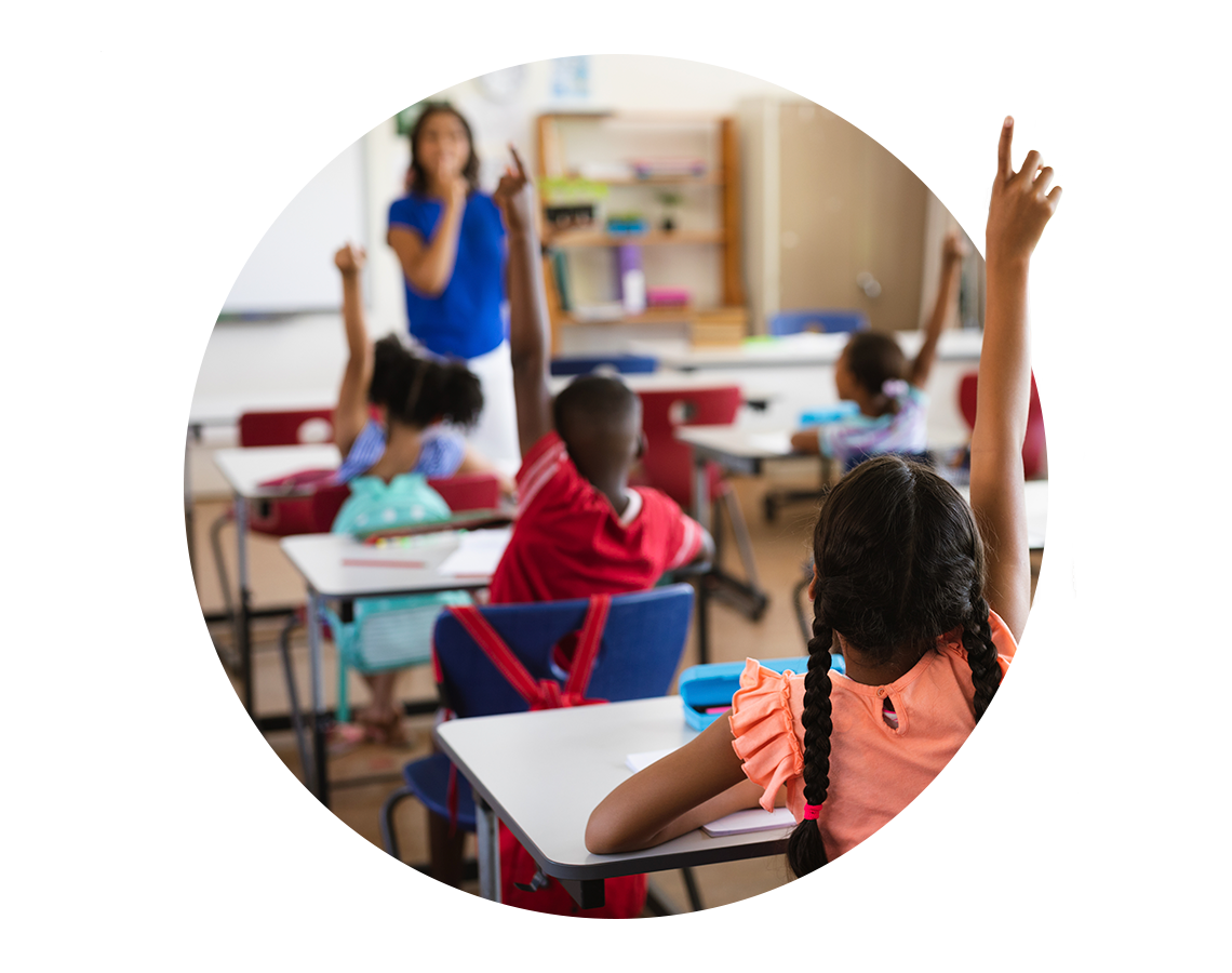 Children raising their hands in a classroom