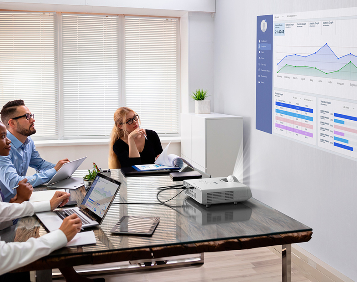 Professionals looking at a projected data visualization
