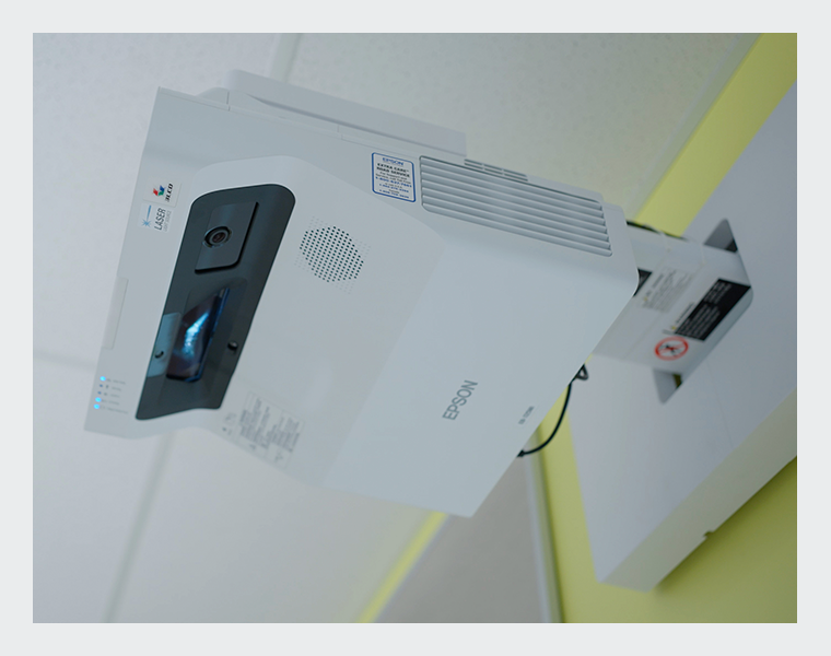 Brightlink projector installed in a classroom above a whiteboard