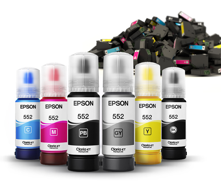 EcoFit ink bottles sitting in front of a pile of discarded ink cartridges