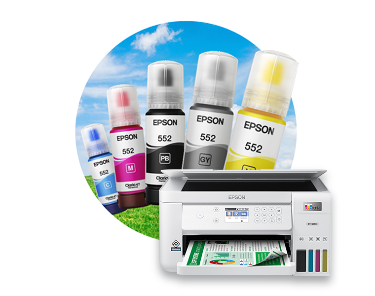 Ink bottles of various colors in front of green grass and a clear sky.