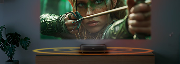 A vivid display projected above a Lifestudio Grand projector, with the sound waves visualized by rings emanating from the projector
