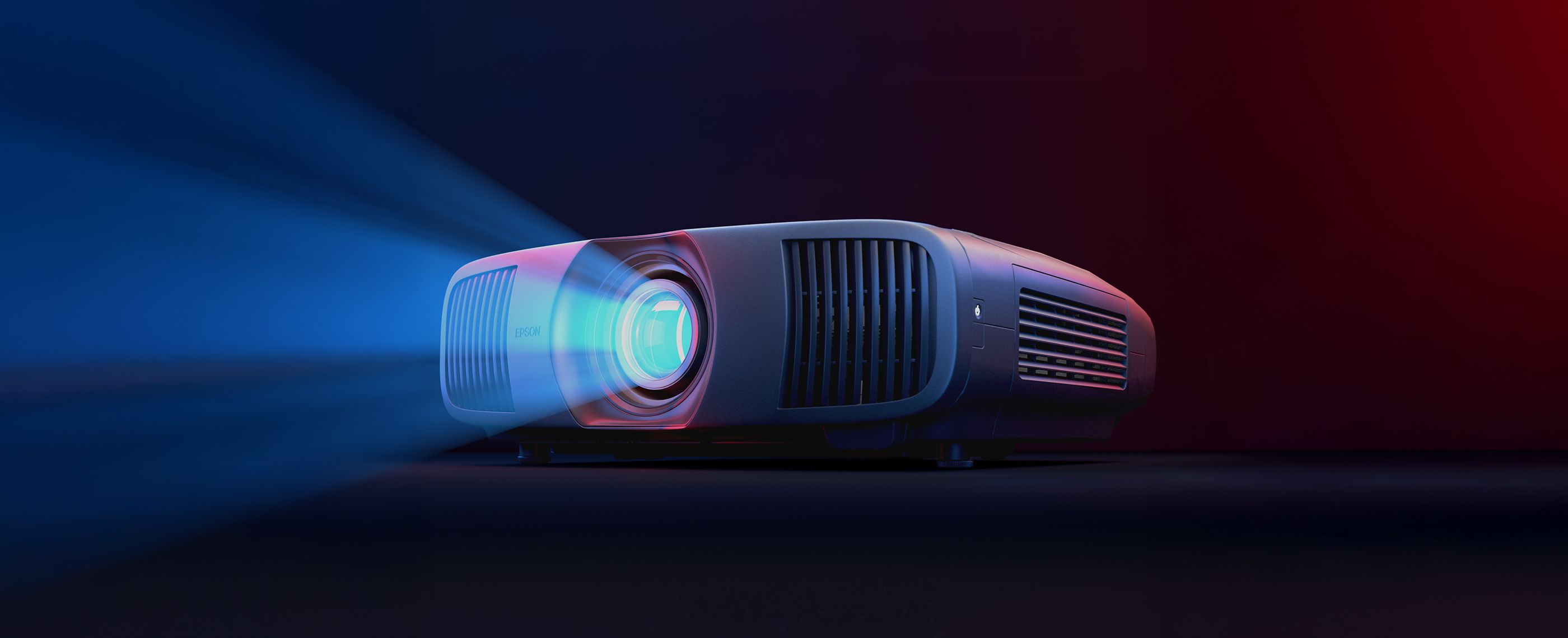 An Epson Pro Cinema Projector emitting light in a dark room
