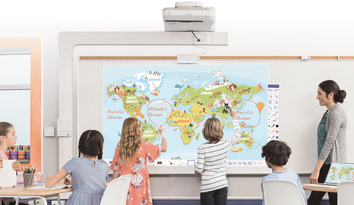 Students interacting with a projected image on a whiteboard