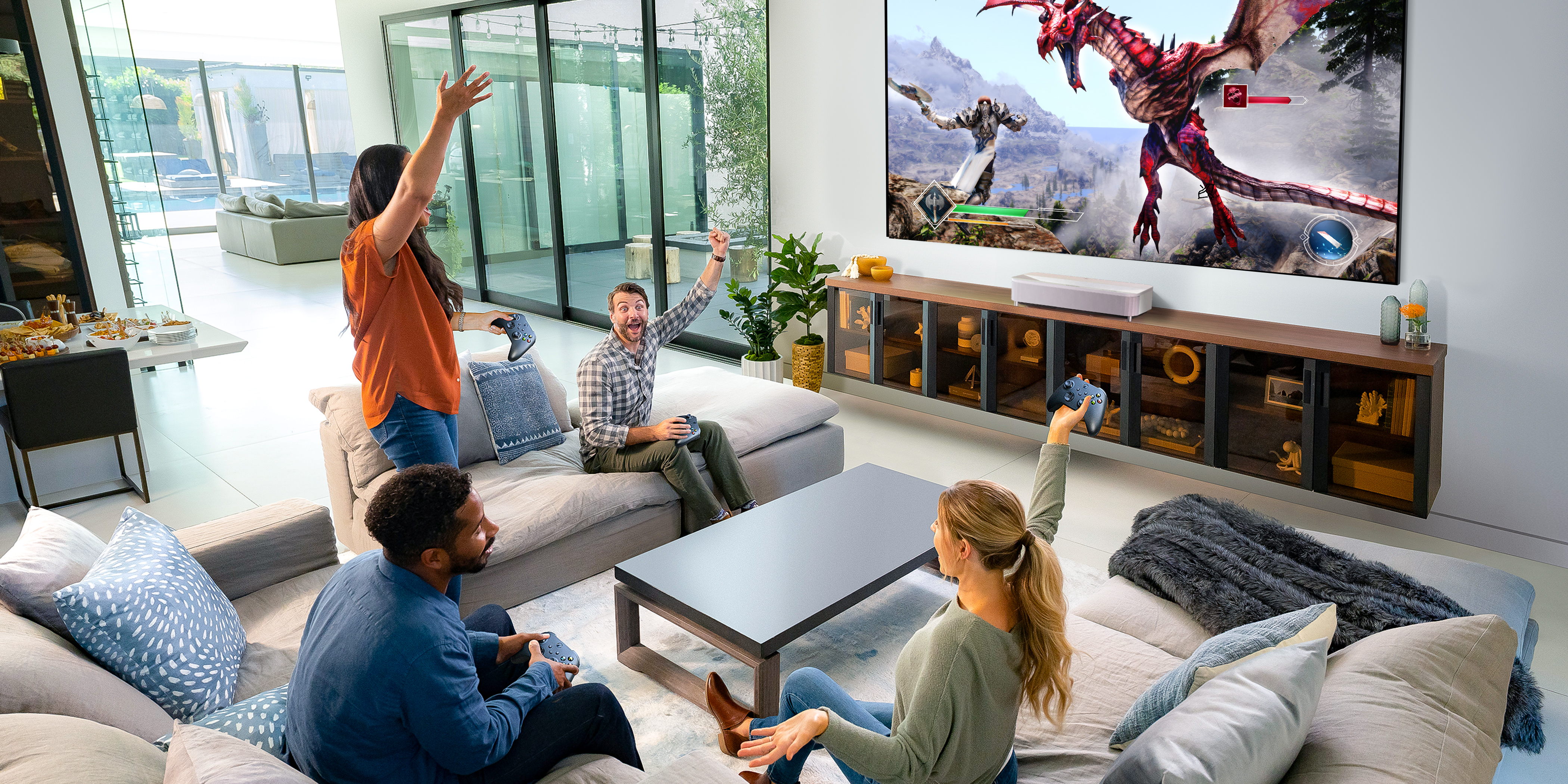 Gamers in a living room playing a fantasy game on a large projected display.