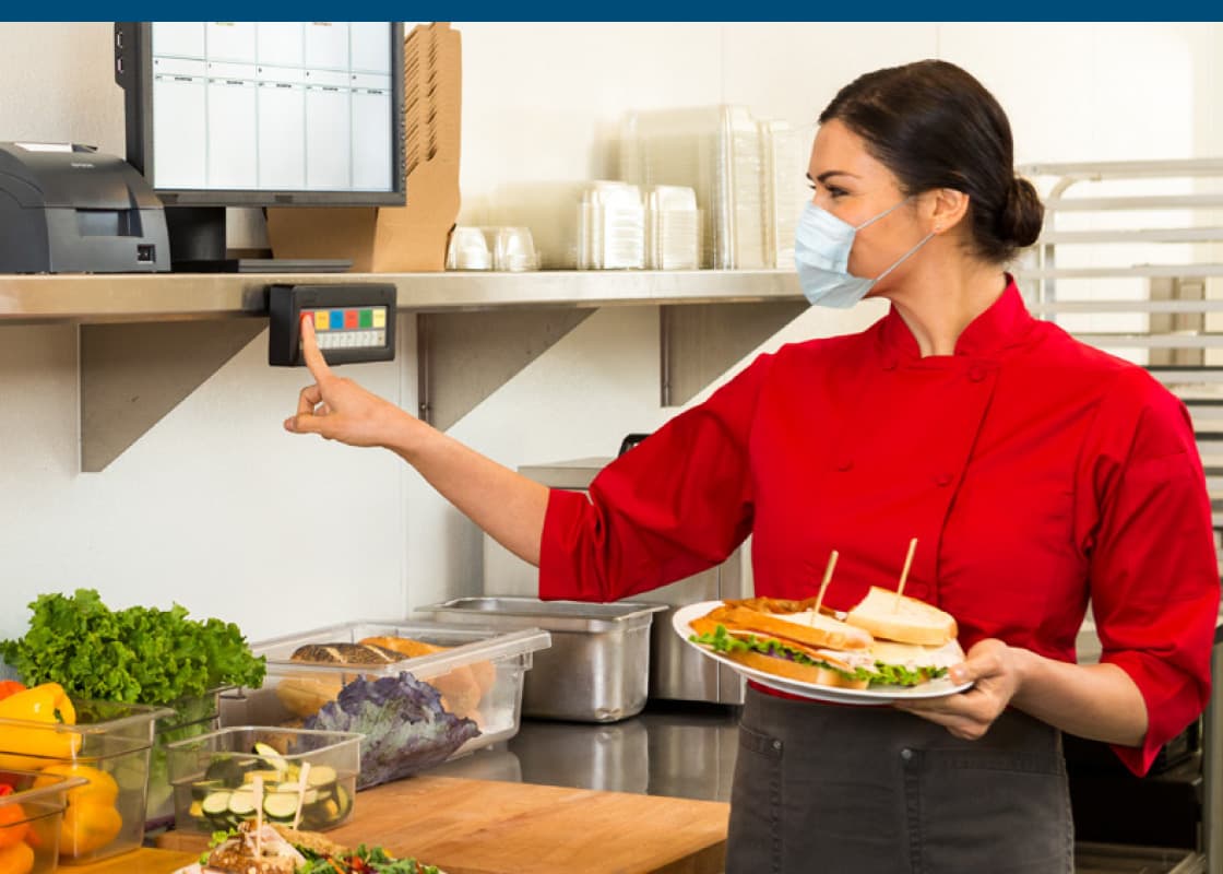 Kitchen employee preparing to serve an order
